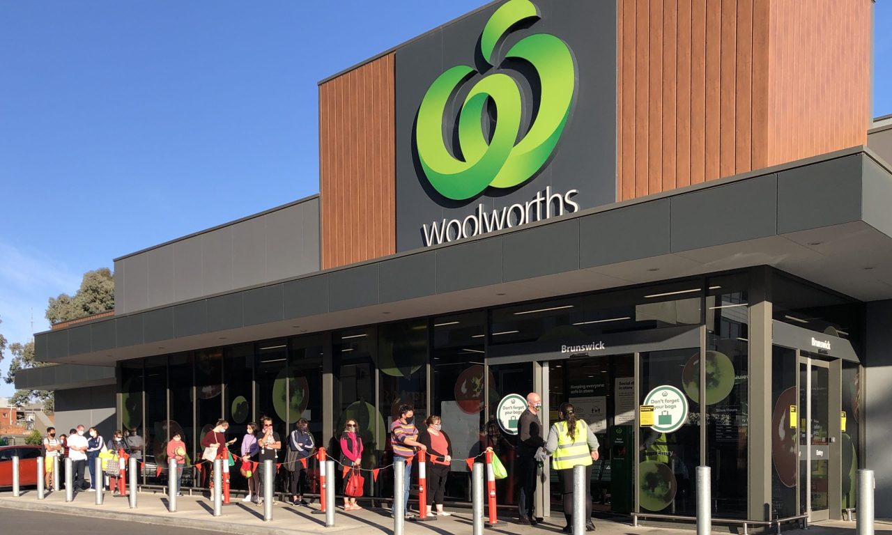 A Woolworths shopping centre in Brunswick, Melbourne, Victoria has a line of people waiting to purchase food and supplies, hours after hearing the news that Melbourne will begin stage 4 lockdown, because of the Coronavirus Pandemic
