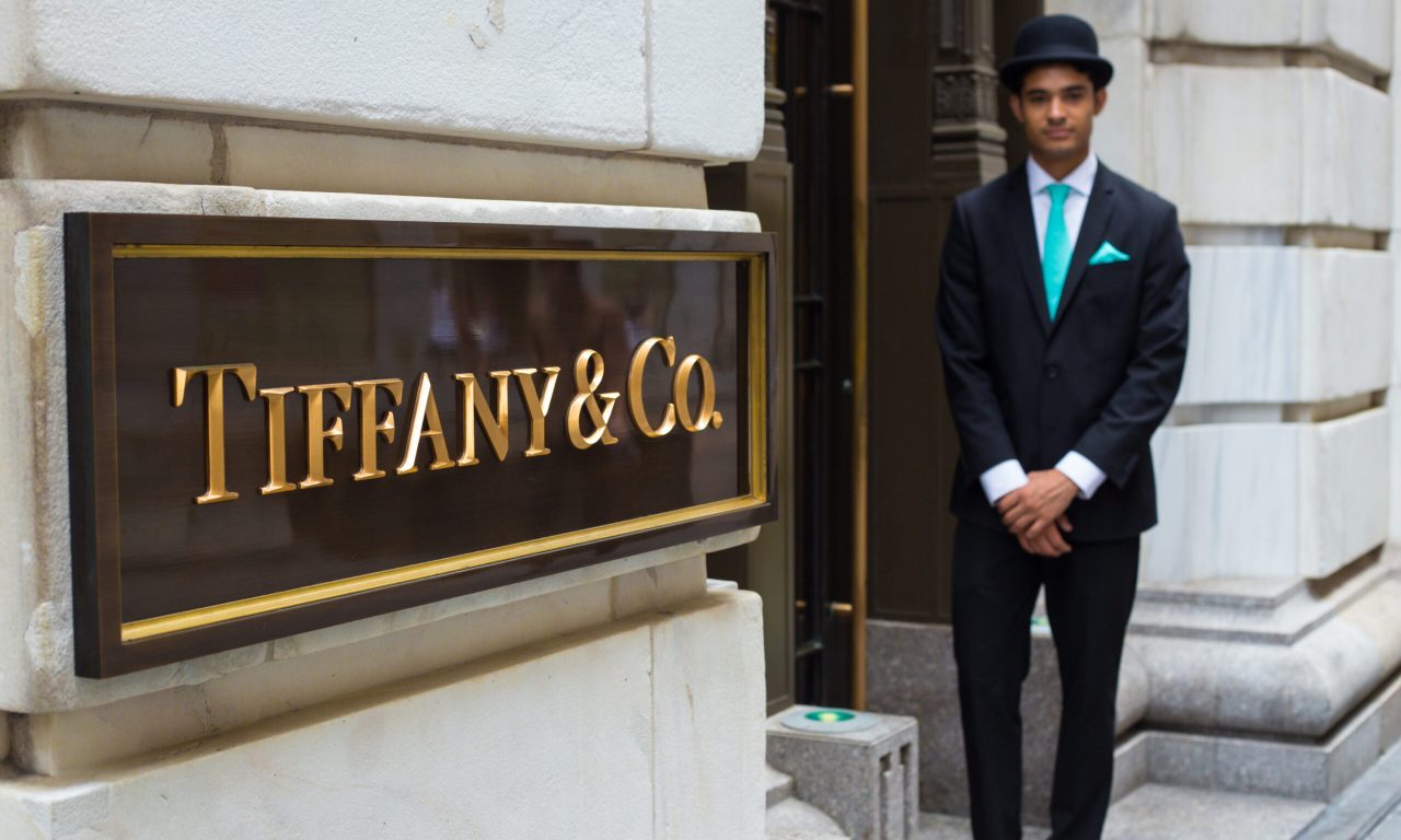New York City, New York, USA - August 3, 2014: View of Tiffany & Co. Building on Wall Street in the Financial District in Manhattan with doorman.  Tiffany's is a luxury American multinational jewelry and silverware corporation.